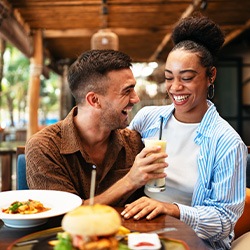 Couple smiling while enjoying meal at restaurant