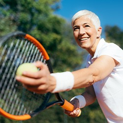 Closeup of woman smiling while playing tennis