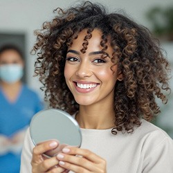 Woman smiling while looking at reflection