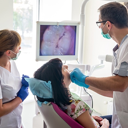 Dentist and patient looking at intraoral images