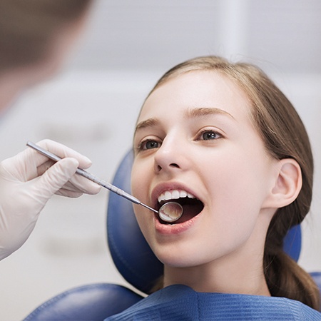 Young girl receiving dental exam