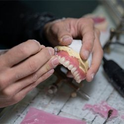 a lab technician constructing a denture