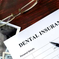 Dental insurance paperwork on a wooden desk