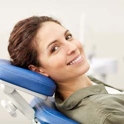 Woman in dentist’s chair smiling