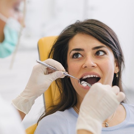 A woman having a dental exam.