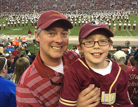 Dr. Fana and son at football game