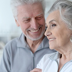 Older couple with grey hair smiling together