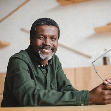 man with dental implants in Savannah sitting at a table