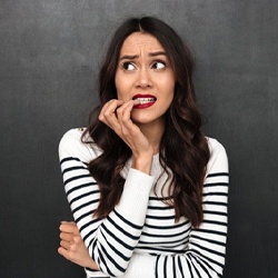 woman nervously biting her fingernails