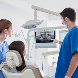 dentist showing a patient their dental X-rays