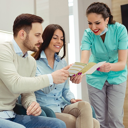 Man and woman looking at dental patient forms