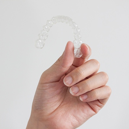 Patient holding clear aligner