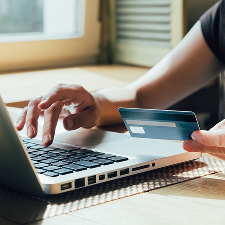 Woman using credit card online