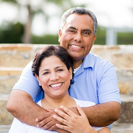 Older man and woman smiling outdoors