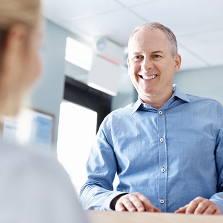 Man checking in at reception desk