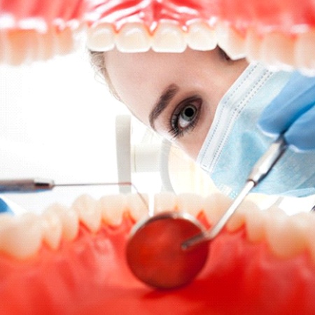 A dentist performing an oral exam.