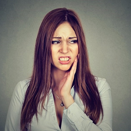 Woman with toothache wonders about root canal therapy