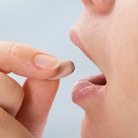 Woman taking sedative pill