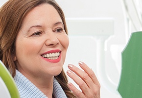 Older woman smiling in dental chair