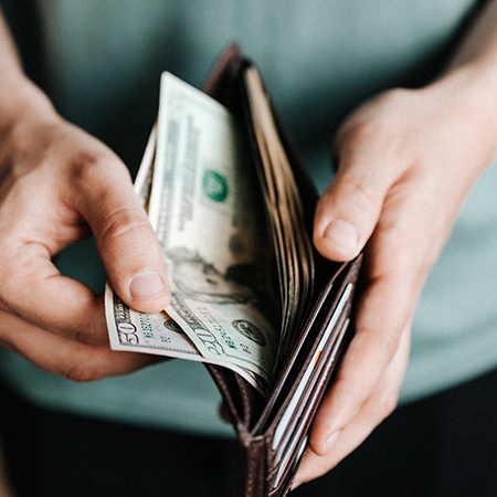 Man holding open wallet with money