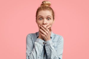 shocked woman covering mouth