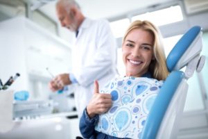 woman giving thumbs up while seeing dentist in Savannah