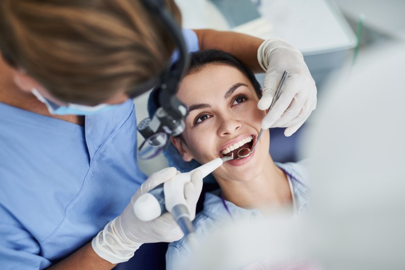 a patient receiving dental fillings from her dentist