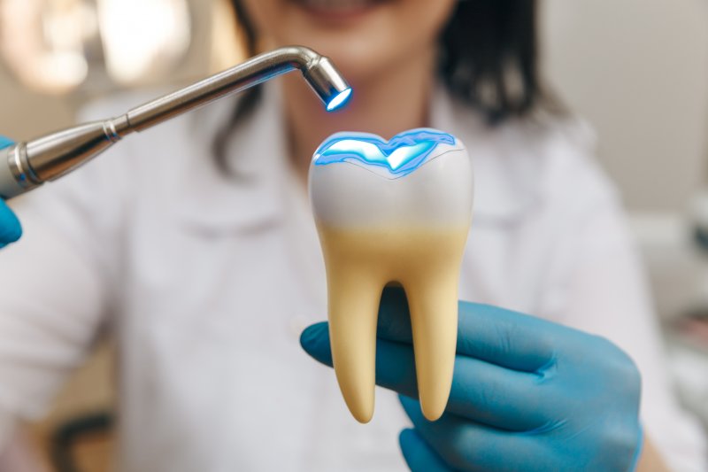 A dentist demonstrating how she does a dental filling