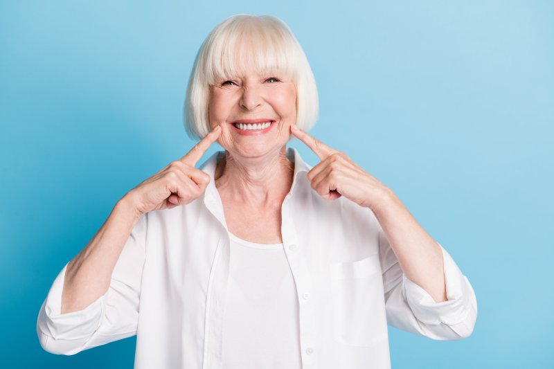 Older woman smiling with her secure lower denture