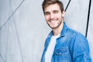 Smiling man wearing a jean jacket