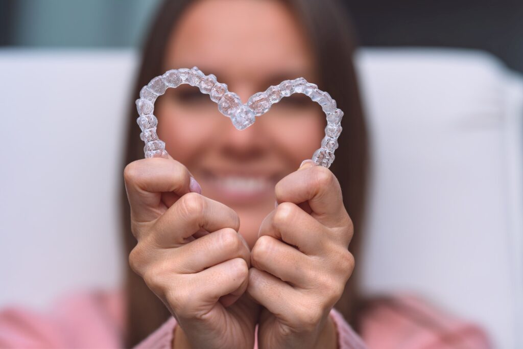 Woman holding Invisalign in heart shape
